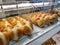 Various type of sweet buns displays on display rack in the bakery shop.