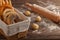 Various types of bread in a basket with small balls of dough and rolling pin