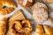 Various types of bread, buttery croissants, breads, rolls, baguettes, Fresh baked goods, flat lay