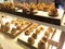 Various types of breads are displayed for sale inside the bakery display rack.