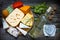Various types of cheese with bottle of wine on old retro boards still life