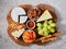 Various types of cheese with mango, ginger, cranberry, Camembert with olives, grapes, chutney, crostini sticks, pecans nuts, over