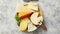 Various types of cheese served on rustic wooden board