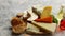 Various types of cheese served on rustic wooden board