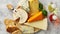 Various types of cheese served on rustic wooden board