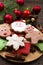 Various types of Christmas gingerbread cookies with fir tree branches, cinnamon sticks, anise star, candle and decoration close up