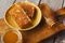 Various types of honey on wooden platter, closeup