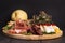Various types of italian appetizers: ham, cheese, grissini, olives, fruits