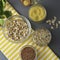 Various uncooked cereals. Different types of groats in bowls on gray background, top view, close up. Healthy nutrition food.