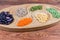 Various uncooked legumes on the wooden serving dish close-up