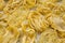 Various uncooked pastafettuccine, pappardelle, tagliolini on white wooden surface, side view.