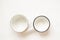 Various used enamel kitchen pots on a white background, a set of pots and a bowl