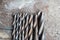 Various used twist drill bits in a row