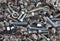 Various, various bolts, nuts, screws and washers lying all together in a heap, top view