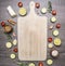 Various vegetables and fruit laid out around a vintage white cutting board place for text,frame wooden rustic background top vi