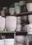 Various white and black terracotta plant pots in marble pattern on shelves display for sale in outdoor market