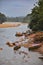 Various wooden canoes on the river bank