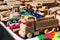 Various wooden toys, trucks, whistles, tanks, buldozer and puzzle displayed in trader booth on outdoor market