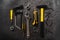 Various yellow repair tools, equipment for building. Grey background top view