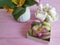 Vase alstroemeria flower, macaron colored wooden background, breakfast, marshmallows