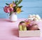 Vase alstroemeria flower, macaron colored wooden background marshmallows