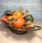 Vase with autumn pumpkins, fallen leaves, cones and acorns, selective focus