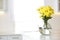 Vase with beautiful yellow chrysanthemum flowers on table in kitchen, space for text. Stylish element of interior design