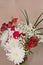 vase of colorful, cut flowers with green, narrow leaves