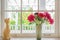 Vase with a flower and cat doll on the windowsill country house