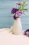 Vase flowers bell, purple chrysanthemum arrangement on a wooden background