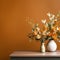 a vase of flowers on a table in front of an orange wall
