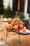 A vase of fruit on the outdoor veranda. Countertop, wet from the rain.