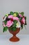 A vase with handmade soap in the shape of flowers raspberries blackberries