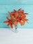 Vase orange lily celebration on a wooden background