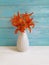 Vase orange lily nostalgia decoration plant retro blooming composition on a wooden background