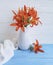 Vase orange lily retro holiday blooming composition design on a wooden background textiles