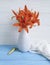 Vase orange lily retro holiday composition nostalgia on a wooden background textiles