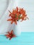 Vase orange lily retro holiday composition on a wooden background textiles