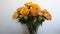 Vase of variegated yellow and red roses