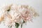 Vase with white chrysanthemum on a table of wooden planks