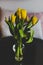 Vase of yellow tulips on table in indoor settings