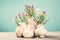 Vases with beautiful flowers on light table