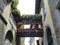 Vases of flowers among two medieval houses to Bergamo in Italy.