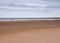 Vast beach and horizon with figures, Norfolk, UK