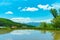 Vast blue sky and white clouds over paddy farmland field in a beautiful sunny day in springtime. Panoramic rural landscape