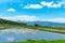 Vast blue sky and white clouds over paddy farmland field in a beautiful sunny day in springtime. Panoramic rural landscape