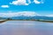 Vast blue sky and white clouds over paddy farmland field in a beautiful sunny day in springtime. Panoramic rural landscape