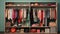 a vast closet filled with an extensive collection of clothes, a woman donning a stylish and aesthetic outfit in the