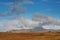 Vast empty field and Croagh Patrick mountains with clouds look like volcano eruption. Stunning Irish landscape. Beautiful nature