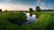 A vast green grass meadow with a winding river